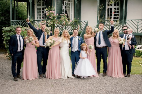 Bridesmaids in pink bride groom and little flower girl