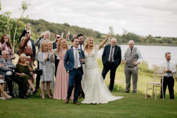 Lake in background family bride bridesmaid and guests