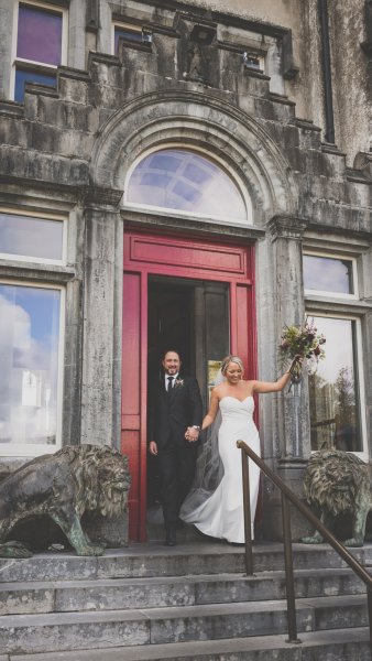 Bride and groom exiting wedding venue