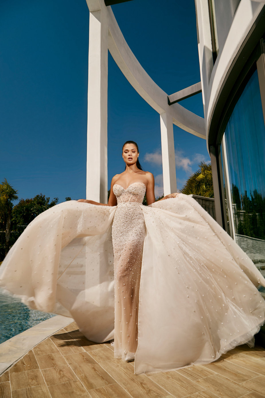 Galia Lahav Spring 2023 Rise Collection Quinn Overskirt bridal gown/dress bride beside swimming pool