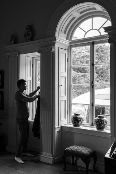 Groom black and white getting ready