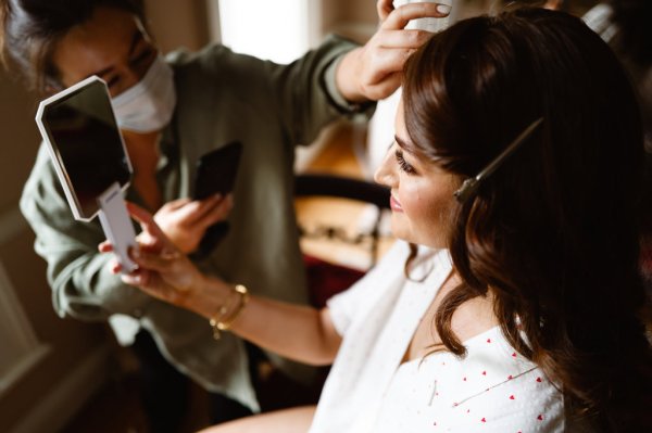 Close up detail of bride getting hair done hairstylist