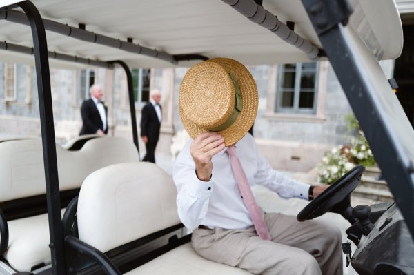 Man with straw hat in wedding cabby/car