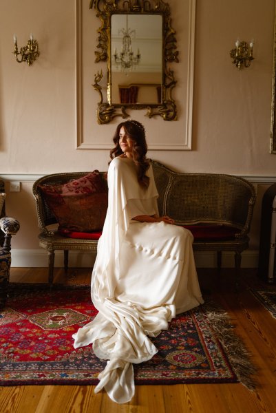 Bride sits on chair/sofa