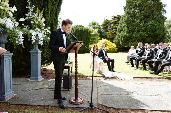 Bride and groom at alter speeches from guests best man