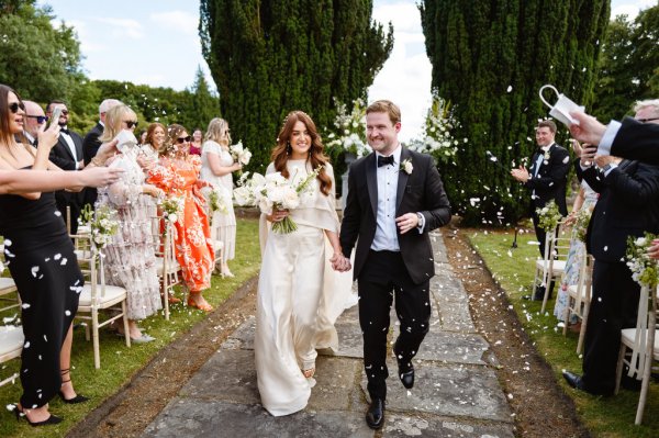 Ceremony and guests bride and groom confetti