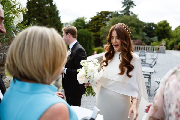 Bride holding white roses/flowers bouquet