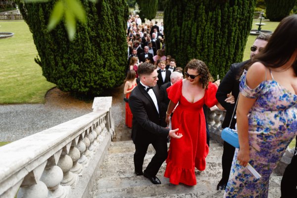 Lady in red walks up the steps staircase