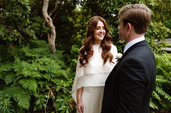 Bride and groom look at each other park/forest