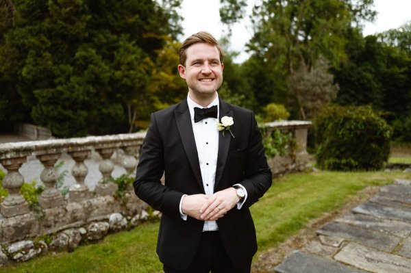 Groom on his own standing on grass