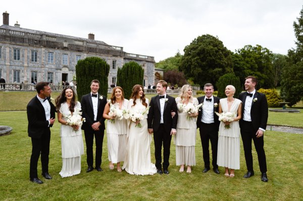 Bride and bridesmaids holding flowers/bouquet with mother father and groom