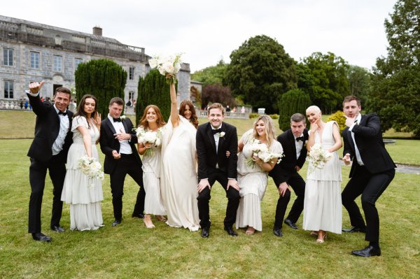 Bride and bridesmaids holding flowers/bouquet with mother father and groom