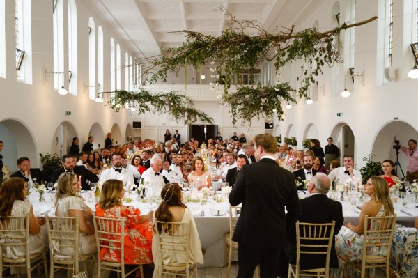 Groom gives speech at table