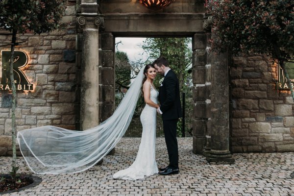 Exterior bride and groom in courtyard