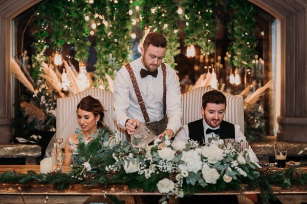 Groom bride and groomsman at table