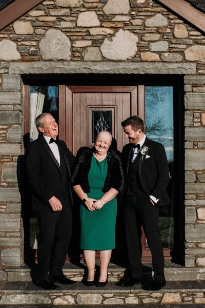 Groom father and mother outside house