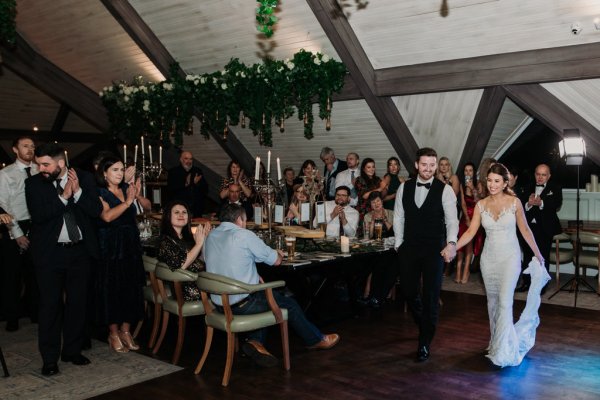 Bride and groom on the dancefloor surrounded by guests