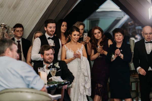 Bride groom and guests clap