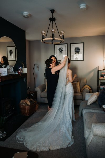 Mother helps fix brides veil