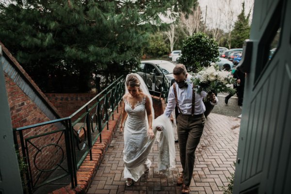 Groom and bride walk into venue