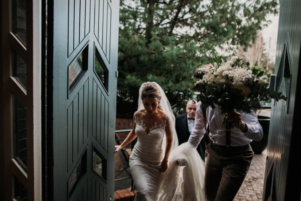 Groom and bride walk into venue