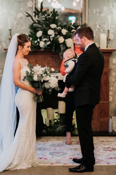 Bride and groom at alter roses flowers