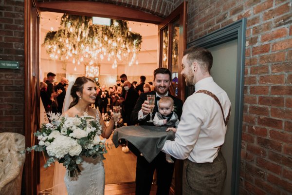 Bride groom little baby boy flowers and champagne