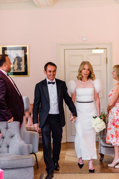 Bride groom enter ceremonial room holding hands