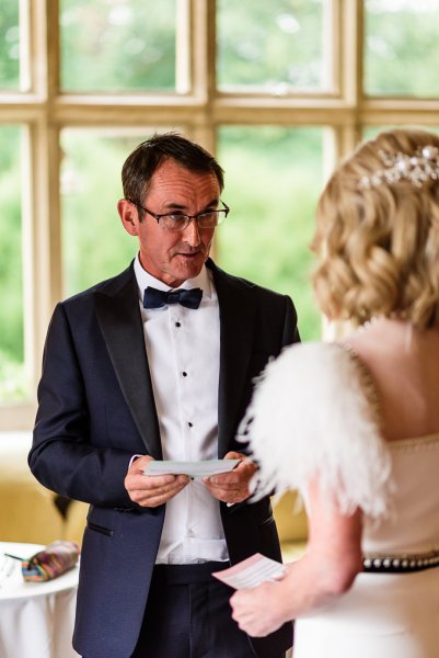 Groom reads his vows to bride