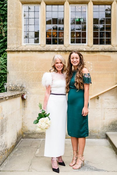 Bride exterior shot with guest/bridesmaid