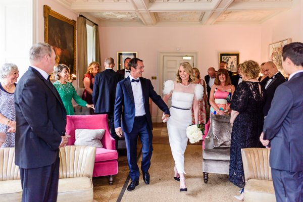 Bride and groom enter ceremonial room hand in hand