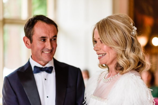 Bride and groom smiling looking at each other