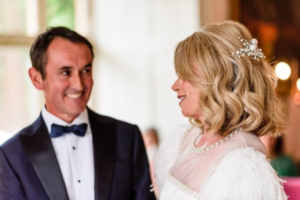 Bride and groom smiling looking at each other