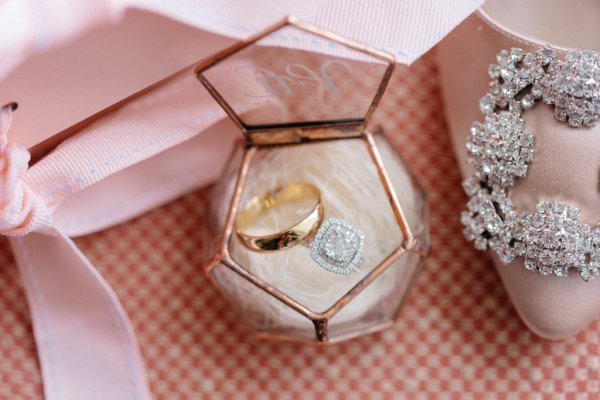 Glass box with wedding band/ring diamond rings inside