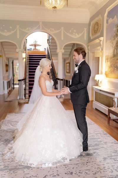 Bride and groom hold hands