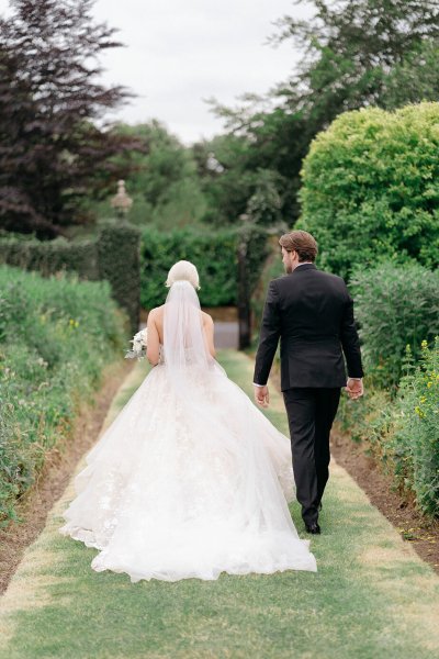 Back of brides dress bride and groom walking