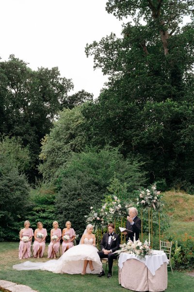 Bride and bridesmaids groom exterior shot