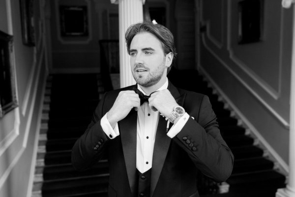 Black and white groom suit and tie stairs in background