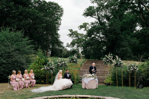 Bride and groom with officiant during ceremony