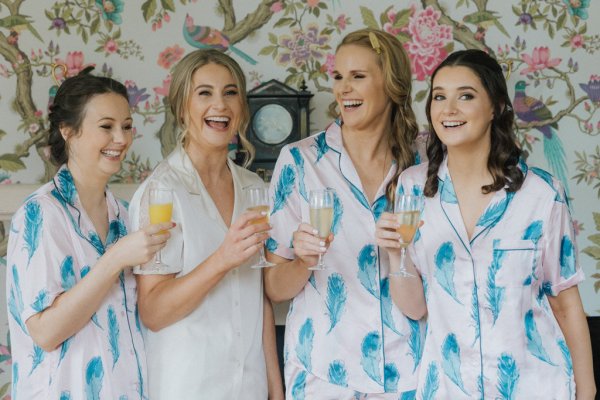 Bridesmaids and bride cheers with prosecco champagne