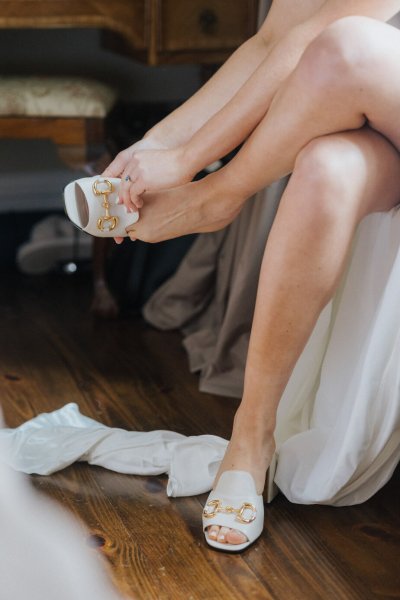 Bride putting in bridal heels/shoes