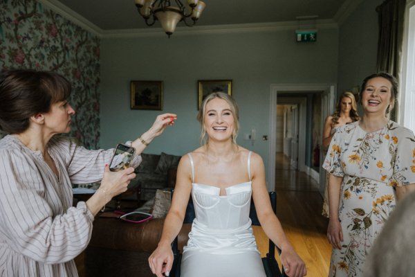 Bride getting ready hairstylist bridesmaids