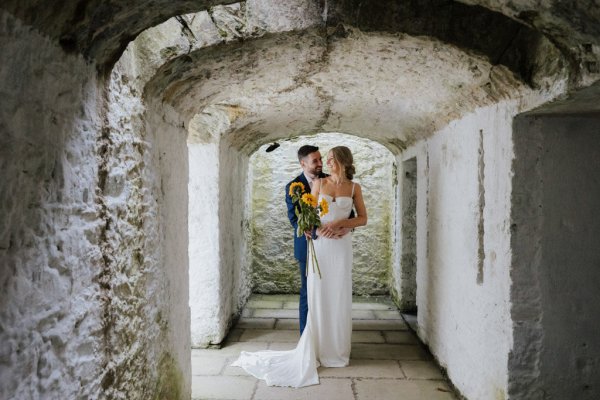 Bride and groom under arch