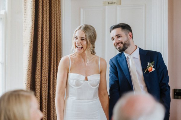 Bride and groom laugh laughing