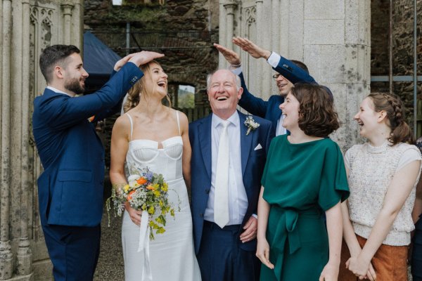 Bride groom mother and father laughing smiling