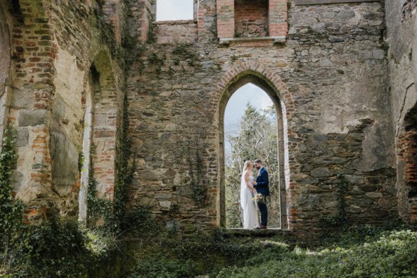 Couple standing under archway