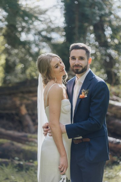 Bride and groom hug outside