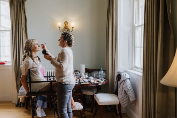 Bride gets her makeup done by MUA