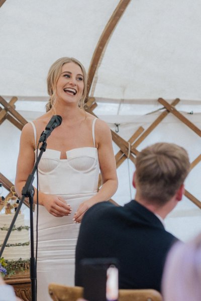 Bride gives speech in marquee/tent microphone