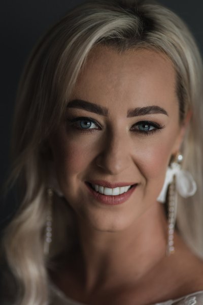 Close up of bride smiling earring detail